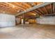 Unfinished basement with concrete floors and open ceiling, offering potential for customization at 15802 Xanthia Way, Thornton, CO 80602