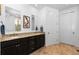 Granite topped double vanity featuring framed mirrors and bronze fixtures at 15802 Xanthia Way, Thornton, CO 80602
