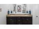 Granite topped double vanity featuring framed mirrors and bronze fixtures at 15802 Xanthia Way, Thornton, CO 80602