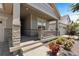 Welcoming front porch with stone accents, flowers, and a cozy entrance at 15802 Xanthia Way, Thornton, CO 80602