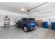 Spacious two car garage with epoxy floor and storage shelving at 15802 Xanthia Way, Thornton, CO 80602