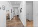 Bright hallway with wood floors leading to the front door and other rooms at 15802 Xanthia Way, Thornton, CO 80602