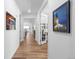 Bright hallway with light wood floors leads to various rooms, offering a clean and welcoming transition at 15802 Xanthia Way, Thornton, CO 80602