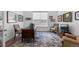 Bright home office with a traditional wooden desk, stylish rug, and natural light from the window at 15802 Xanthia Way, Thornton, CO 80602