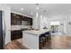 Open kitchen layout with a central island, stainless appliances, and dining area access at 15802 Xanthia Way, Thornton, CO 80602