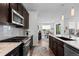 Updated kitchen featuring stainless steel appliances, granite counters, and stylish backsplash at 15802 Xanthia Way, Thornton, CO 80602