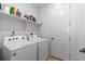 Well-organized laundry room featuring a washer, dryer, and ample shelving for storage and convenience at 15802 Xanthia Way, Thornton, CO 80602