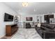 Upstairs living room featuring hardwood floors, stylish decor and a large screen tv at 15802 Xanthia Way, Thornton, CO 80602