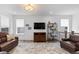 Upstairs living room featuring hardwood floors, stylish decor and lots of light and a TV at 15802 Xanthia Way, Thornton, CO 80602