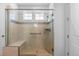 Glass enclosed shower featuring a bench, handheld shower and a built in niche at 15802 Xanthia Way, Thornton, CO 80602
