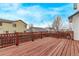 Wide-angle view of a stained wooden deck with railing, overlooking nearby homes at 18948 E Baker Pl, Aurora, CO 80013