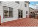 A spacious, stained wooden deck is attached to this charming home's white vinyl siding at 18948 E Baker Pl, Aurora, CO 80013