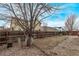A fenced backyard with a ground cover of decorative stones and bare trees in the distance at 18948 E Baker Pl, Aurora, CO 80013