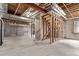 Unfinished basement with concrete floor, exposed ceiling, and stud wall framing at 18948 E Baker Pl, Aurora, CO 80013