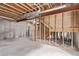 Unfinished basement with concrete floor, exposed ceiling, and stud wall framing at 18948 E Baker Pl, Aurora, CO 80013