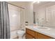 Bathroom with a single sink vanity, tub-shower combo, and neutral tile flooring at 18948 E Baker Pl, Aurora, CO 80013
