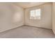 Neutral bedroom with a large window providing natural light, and carpeted floor at 18948 E Baker Pl, Aurora, CO 80013