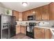 A practical kitchen with dark appliances and ample cabinet space is ready for meals at 18948 E Baker Pl, Aurora, CO 80013