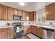 The functional kitchen has wooden cabinets and essential appliances at 18948 E Baker Pl, Aurora, CO 80013