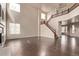 Spacious living room with soaring ceilings and a wooden staircase creates an airy atmosphere at 18948 E Baker Pl, Aurora, CO 80013