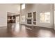Bright living room features a fireplace, wood floors, and flows into the kitchen area at 18948 E Baker Pl, Aurora, CO 80013