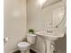 A simple powder room features a pedestal sink and neutral decor at 18948 E Baker Pl, Aurora, CO 80013