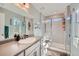 Bathroom features white cabinets, brushed nickel hardware, sleek countertops, and a glass enclosed shower and a large mirror at 3075 Distant Rock Ave, Castle Rock, CO 80109
