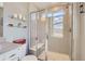 Bathroom featuring a glass enclosed shower with a built in seat, and gray tile at 3075 Distant Rock Ave, Castle Rock, CO 80109