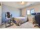 Well-lit bedroom featuring a comfortable bed, desk, and a window with natural light at 3075 Distant Rock Ave, Castle Rock, CO 80109