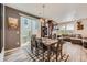 Dining area is open to the living room and offers access to the backyard, and features a designer rug and sliding glass doors at 3075 Distant Rock Ave, Castle Rock, CO 80109