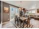 Dining room with modern light fixture, wooden table set, and sliding glass doors to the outdoor patio area at 3075 Distant Rock Ave, Castle Rock, CO 80109