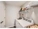 Bright laundry room features modern washer and dryer, and ample shelving for storage at 3075 Distant Rock Ave, Castle Rock, CO 80109