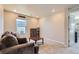 Well-lit living room featuring a comfortable sofa, and a window with natural light at 3075 Distant Rock Ave, Castle Rock, CO 80109