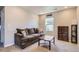Inviting living room with a plush sofa and a window that offers natural light at 3075 Distant Rock Ave, Castle Rock, CO 80109