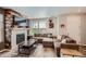 Comfortable living room with wood-burning fireplace, large sectional sofa at 3075 Distant Rock Ave, Castle Rock, CO 80109