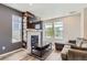 Cozy living room with fireplace, modern tv and windows looking onto outside at 3075 Distant Rock Ave, Castle Rock, CO 80109