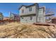 Backyard view featuring a wooden deck, gray siding and trees under a blue sky at 6462 Freeport Dr, Highlands Ranch, CO 80130