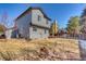 Spacious backyard view of a two story home with neutral colored siding at 6462 Freeport Dr, Highlands Ranch, CO 80130