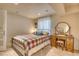 Cozy bedroom featuring a plaid bedspread and a classic vanity at 6462 Freeport Dr, Highlands Ranch, CO 80130