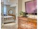 Bedroom view through French doors, showcasing a bed and vanity at 6462 Freeport Dr, Highlands Ranch, CO 80130