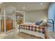 Bedroom showcasing a colorful plaid bedspread and easy access to the living room at 6462 Freeport Dr, Highlands Ranch, CO 80130