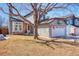 Charming home featuring a brick facade, attached two-car garage, and a well-maintained front yard at 6462 Freeport Dr, Highlands Ranch, CO 80130