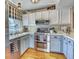 Charming kitchen featuring two-tone cabinets, stainless steel appliances, and bright natural light at 6462 Freeport Dr, Highlands Ranch, CO 80130