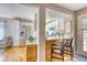 An open kitchen with stainless steel appliances connects to a cozy living area with wood floors at 6462 Freeport Dr, Highlands Ranch, CO 80130