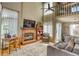 Bright living room showcasing a fireplace, tall ceilings, hardwood floors, and abundant natural light at 6462 Freeport Dr, Highlands Ranch, CO 80130