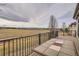 Backyard deck with beautiful expansive field views, wrought iron railing and outdoor tile table at 16399 Somerset Dr, Broomfield, CO 80023
