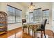 Charming dining area featuring wood floors, natural light from large windows, and seating for two at 16399 Somerset Dr, Broomfield, CO 80023