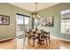 Cozy dining room with round table, chandelier, and a sliding door to the deck at 16399 Somerset Dr, Broomfield, CO 80023