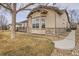 Side view of home with stone accents, patio, manicured lawn and view of expansive field at 16399 Somerset Dr, Broomfield, CO 80023