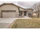 Charming home exterior with stone accents, a two-car garage, and a well-manicured lawn at 16399 Somerset Dr, Broomfield, CO 80023